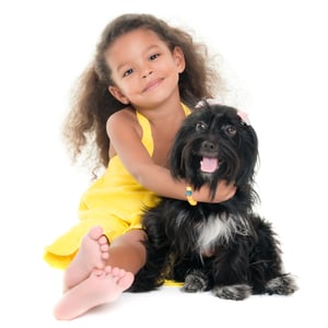 Little girl hugging a puppy