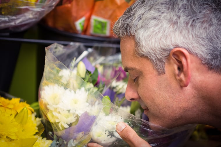 Sensitive Man Enjoying the Scent of Flowers