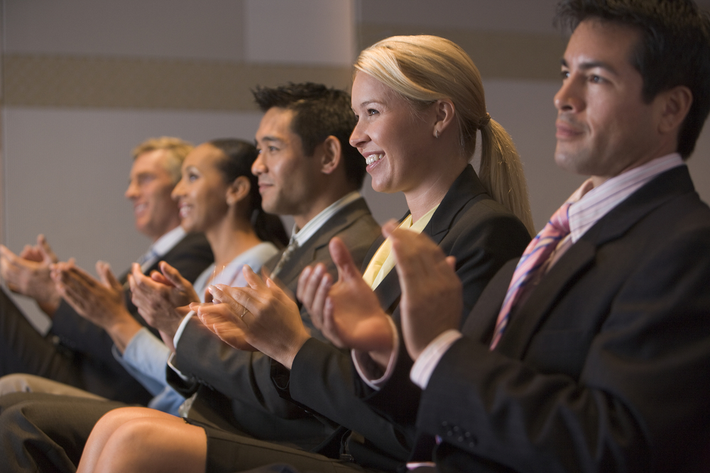 Professional coaches applauding presentation